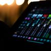A vibrant and colorful digital audio mixer interface captured under studio lighting, showcasing detailed controls.