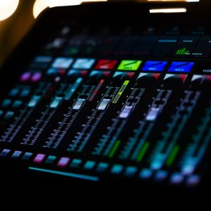 A vibrant and colorful digital audio mixer interface captured under studio lighting, showcasing detailed controls.