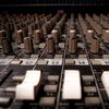 Detailed close-up of a professional sound mixer console in Phnom Penh studio.