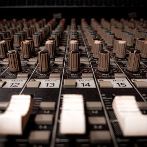Detailed close-up of a professional sound mixer console in Phnom Penh studio.